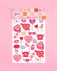 Valentine's temporary tattoos applied on hands showing cherub, bow, lips, heart lock, and gift box designs