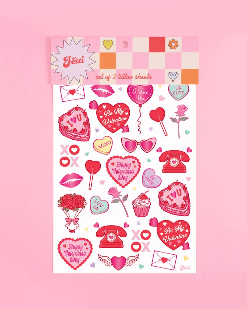 Valentine's temporary tattoos applied on hands showing cherub, bow, lips, heart lock, and gift box designs