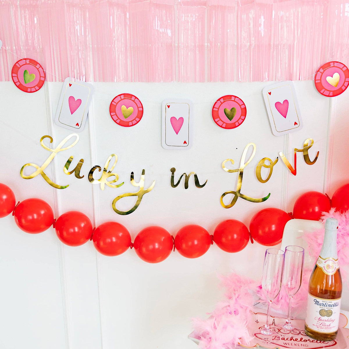 A Lucky in Love Party Sign and coin banner hung as a Vegas suite backdrop for a bachelorette weekend.