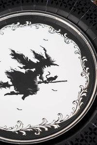 Close up vertical crop of the vintage witch silhouette plate layered neatly over an intricate matte black paper charger.