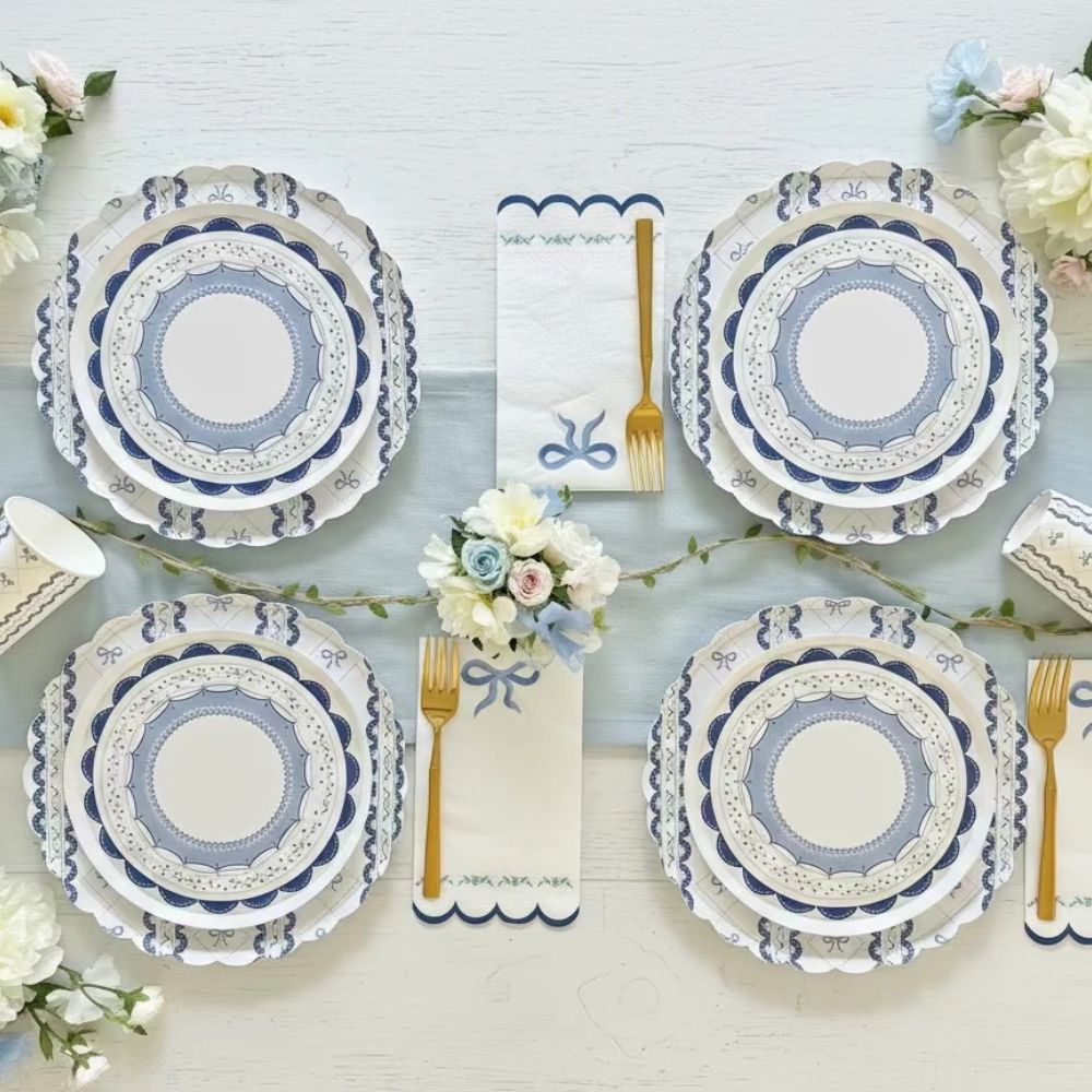 Symmetrical table arrangement featuring blue coquette cups and tableware