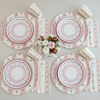 Symmetrical table arrangement with cherry tableware and white forks