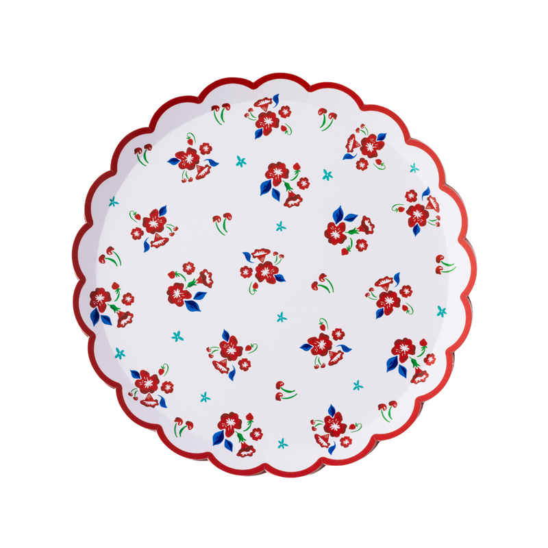 Single vintage floral scalloped paper dessert plate flat lay on white background showing full scattered red flower, blue leaf, and cherry print with red scalloped border
