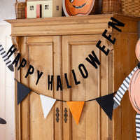 Felt pennant Halloween banner displayed with a Happy Halloween sign over a cabinet.