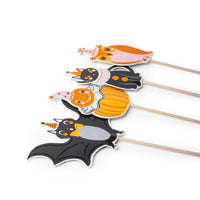 4 vintage Halloween character cupcake toppers on wooden picks: owl, black cat, pumpkin clown, and bat, each in a party hat