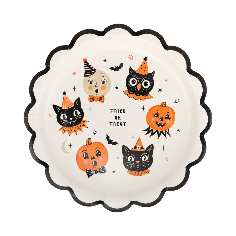 Cream scalloped paper plate with vintage trick-or-treat character icons, front view.