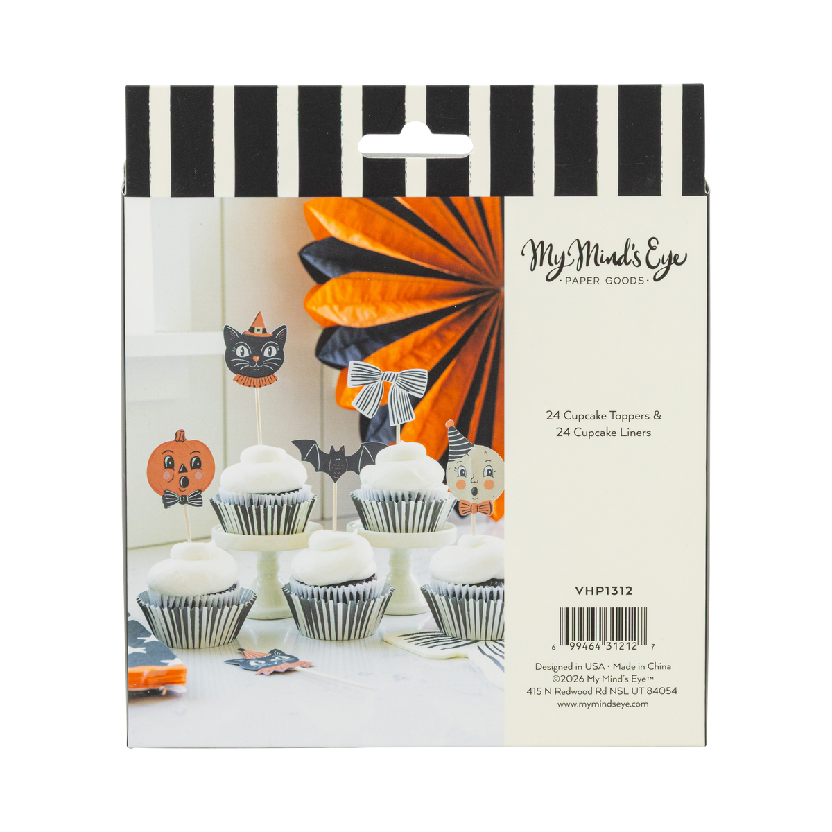 Halloween-themed cupcake packaging with decorative toppers and liners on a black and white striped background.