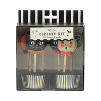 Halloween-themed cupcake kit packaging with black and white striped lid, front view.