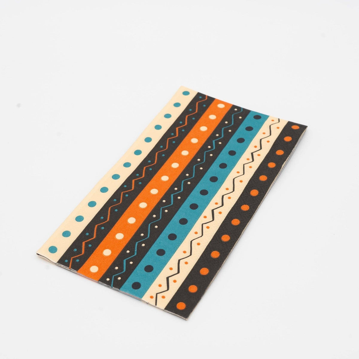 Two folded vintage Halloween guest towels stacked, showing the retro teal-orange-black stripe pattern up close.