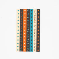 Vintage Halloween guest towel with a vertical retro stripe pattern in teal, orange, black, and cream ric-rac and dots, flat view on white background.