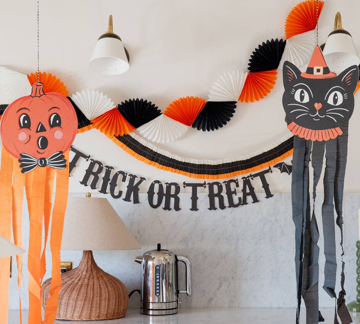 Halloween-themed decorations including a cat, pumpkin, and 'Trick or Treat' banner on a wall.