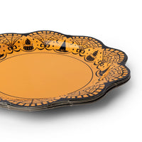 Orange scalloped Halloween paper plate with an ornate black filigree edge and small Halloween icons of bats, pumpkins, and cats around the rim