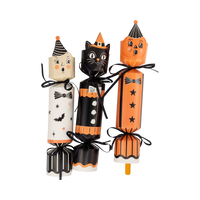 Three Halloween-themed party crackers with cat, witch, and moon designs.
