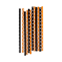 Set of vintage Halloween reusable straws in cream-stars-on-black and ric-rac-on-orange patterns, laid flat.

