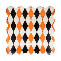 Single 11-inch square harlequin paper plate in orange, black, and cream with scalloped rim on white background.