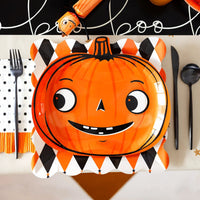 Close-up of harlequin 11" plate layered with a pumpkin plate, showing scalloped edge and diamond pattern.