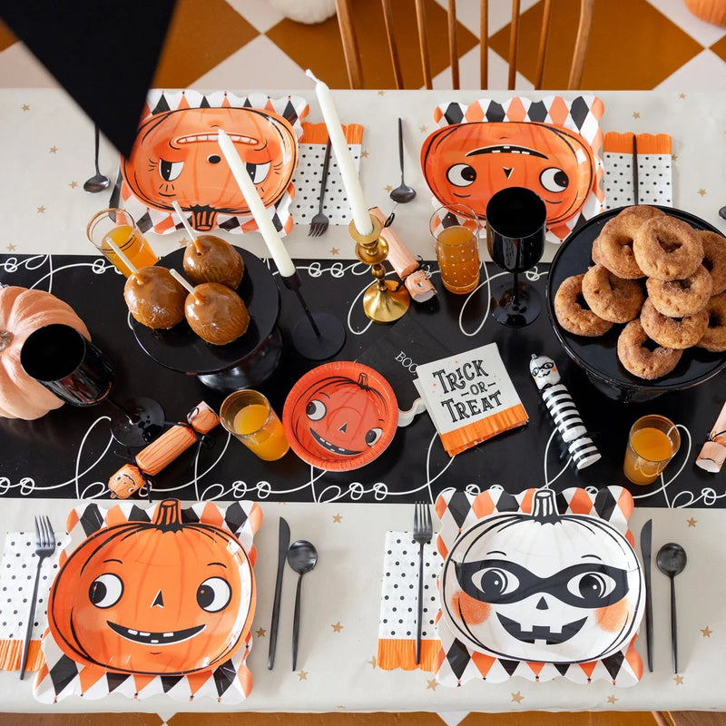 Halloween tablescape styled with Vintage Pumpkin 12 oz paper bowls, coordinating plates, napkins, and party décor.