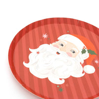 Vintage Santa dessert plate laid flat, showing the candy-cane stripes and Santa artwork.