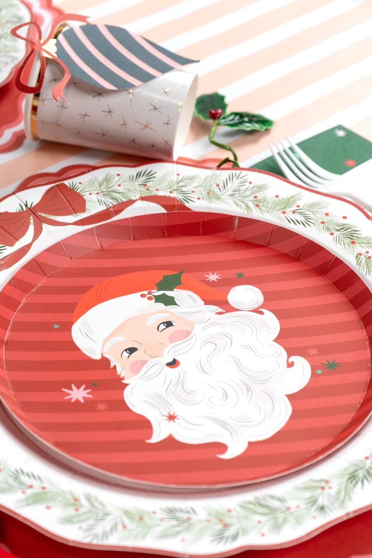 Close-up of the vintage Santa face on the dessert plate with holly and star accents.