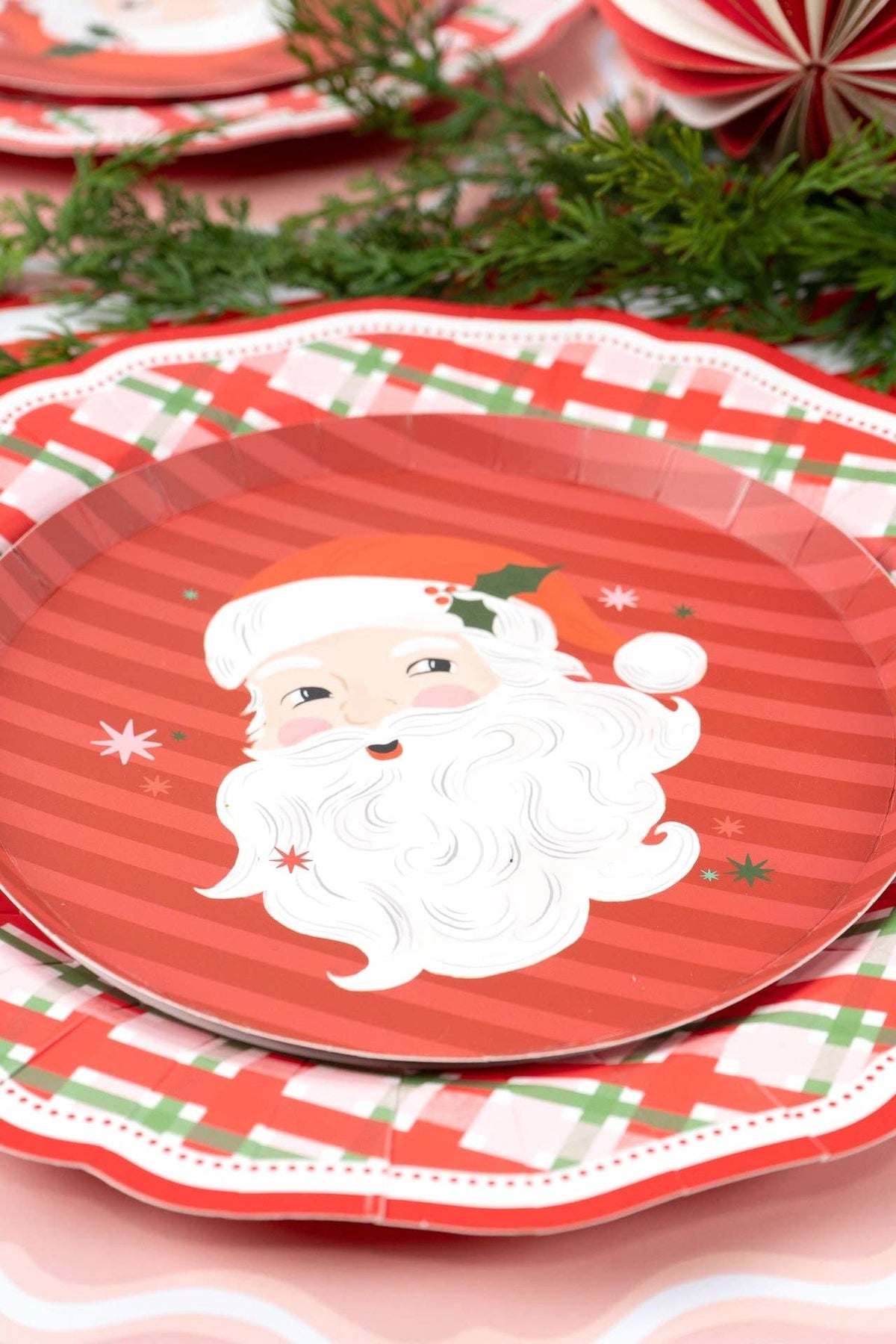 Close-up of the Santa dessert plate showing the candy-cane stripes, Santa face, holly, and stars.
