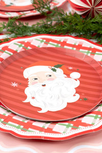 Close-up of the Santa dessert plate showing the candy-cane stripes, Santa face, holly, and stars.