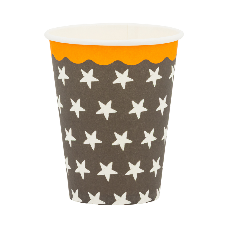 Black paper cup with a cream star pattern and orange scalloped rim, front view. 