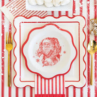 Overhead view of a detailed holiday place setting featuring one of the Christmas plates layered on a larger plate.