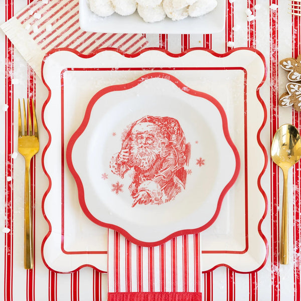 Overhead view of a detailed holiday place setting featuring one of the Christmas plates layered on a larger plate.