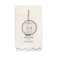 Pack of napkins with Welcome all witches text and branding on a white background, front view.