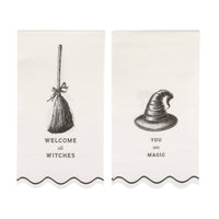 Cream dinner napkin with bold black "WELCOME ALL WITCHES" & "YOU are MAGIC" text and a wavy edge, front view.