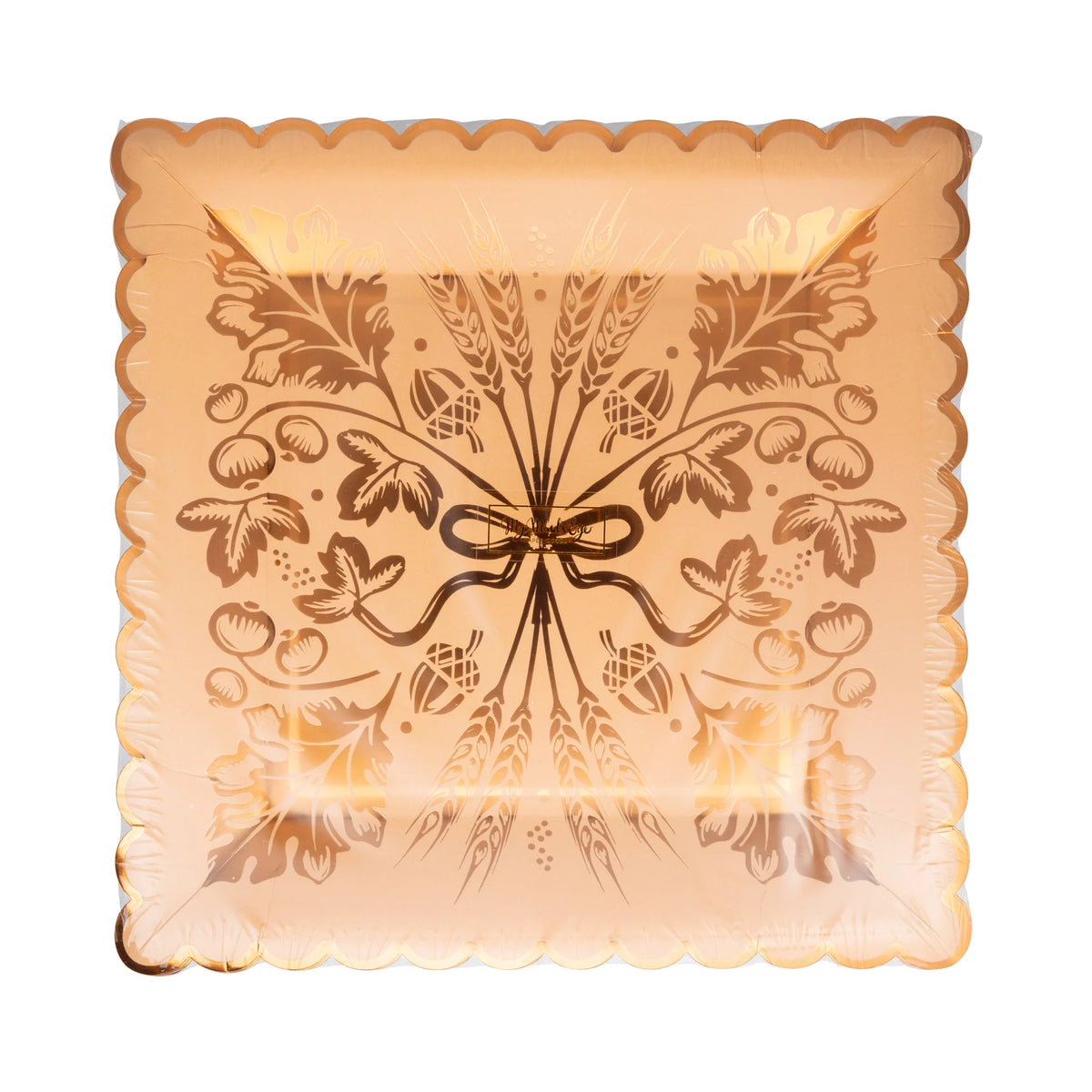 Front of package showing rust-orange plate with copper-foil wheat artwork and scalloped rim.