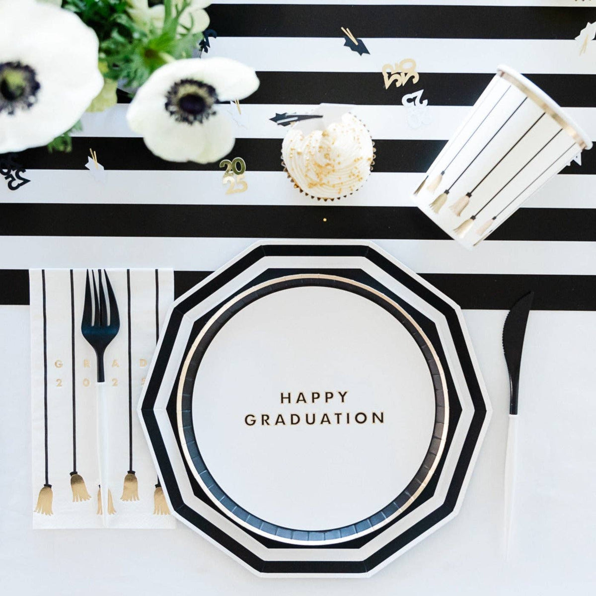 White graduation snack plate with gold lettering saying "Happy Graduation" styled on table