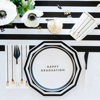 White graduation snack plate with gold lettering saying "Happy Graduation" styled on table