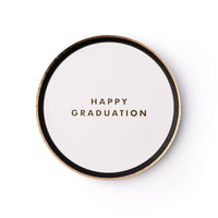 White graduation snack plate with gold lettering saying "Happy Graduation"