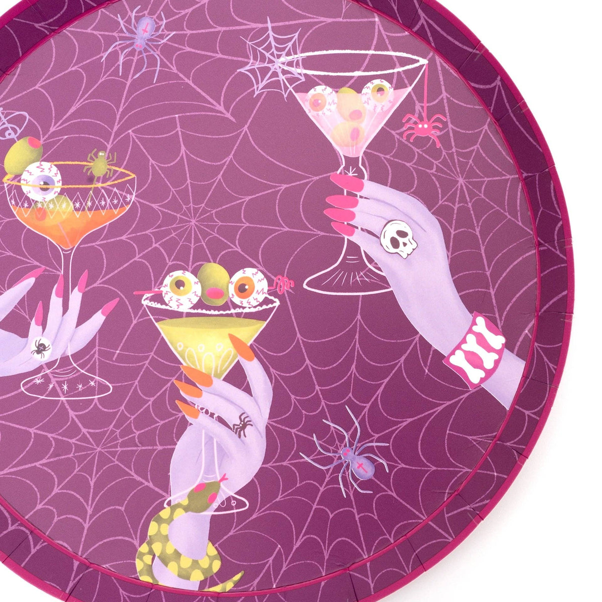 Close up macro view focusing on the delicate white spiderweb background pattern on the plum purple paper dessert plate.