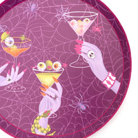 Close up macro view focusing on the delicate white spiderweb background pattern on the plum purple paper dessert plate.
