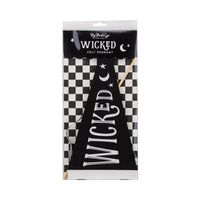 Close-up of WICKED felt pennant—reusable party supplies for spooky styling.