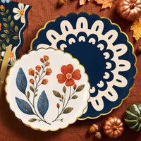 Wildflower dessert plate layered on a navy doily dinner plate on rust linen with copper pumpkins and fall leaves