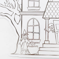 Close up detail of a line-art witch stirring a cauldron on the front steps of the haunted house coloring placemat.