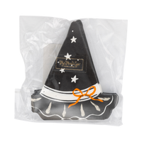 Front of the retail package: the top witch-hat napkin face-up with a small gold brand sticker on the crown — black hat with scattered white stars, a white hatband, an orange tied bow, and a scalloped brim with cream brushstroke accents. Straight-on packaging shot.