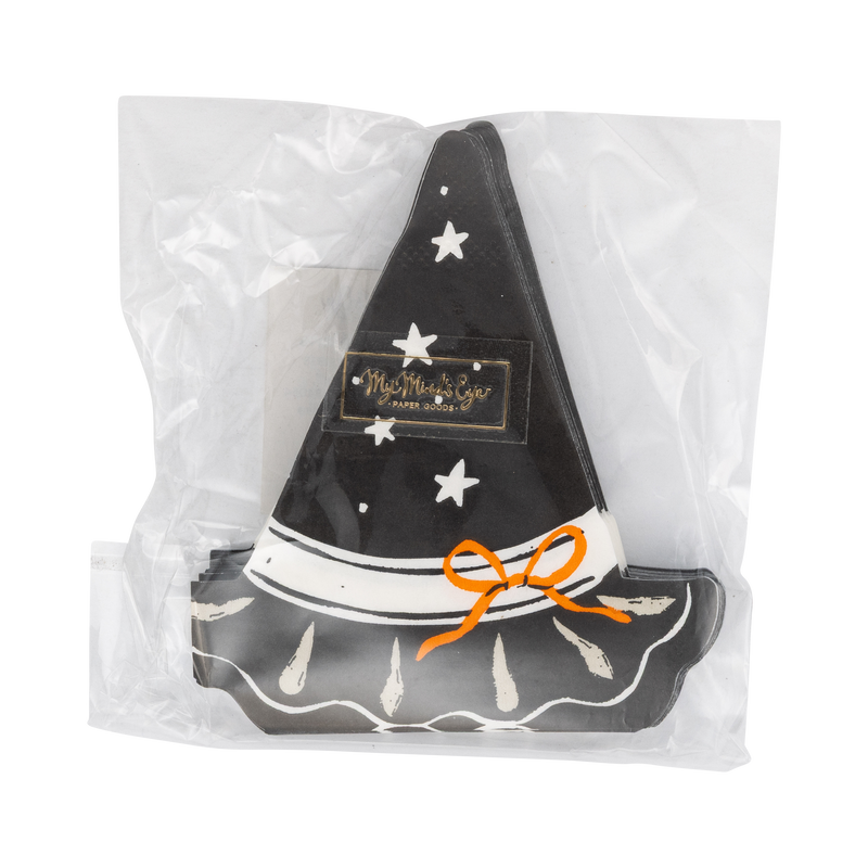 Front of the retail package: the top witch-hat napkin face-up with a small gold brand sticker on the crown — black hat with scattered white stars, a white hatband, an orange tied bow, and a scalloped brim with cream brushstroke accents. Straight-on packaging shot.