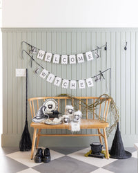 Lifestyle Halloween design with the witch hat plates in use among other party décor.
