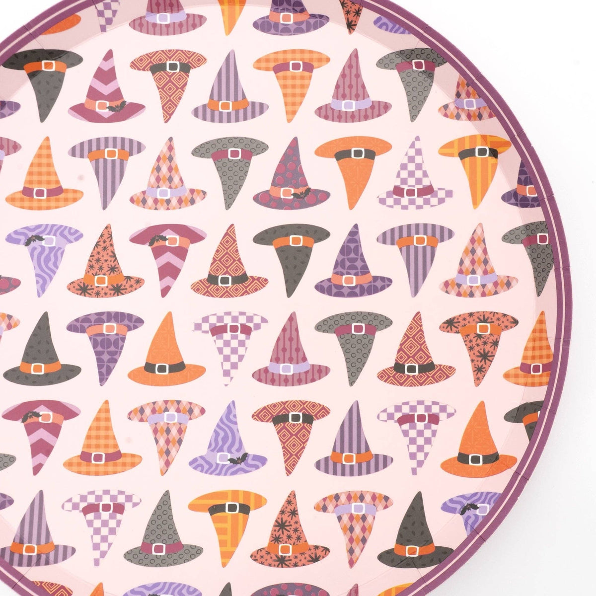 Extreme close-up of the witch hat pattern showing individual hats in stripes, polka dots, and checks in orange, purple, pink, and black.