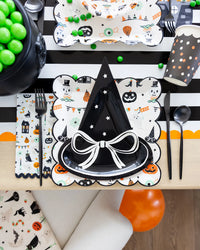 Place setting pairing black witch-hat plate atop Tricks & Treats square Halloween plate.