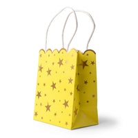 Yellow favor bag, three-quarter view, with gold-foil stars, a scalloped top edge, and white paper handles.