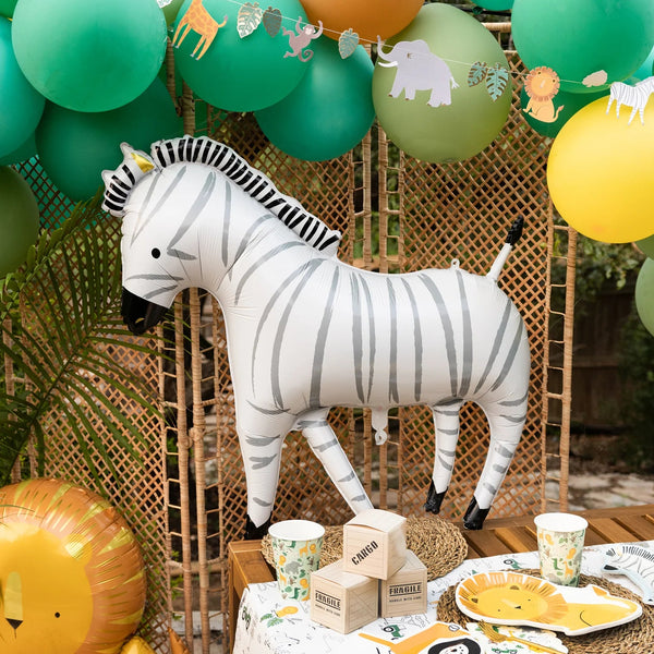 Zebra mylar balloon centerpiece with jungle tableware—instant safari theme party vibe.